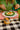 Person eating a meal with a can of Punch on a checkered tablecloth