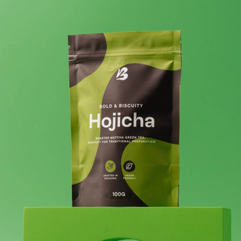 Hojicha tea package on a green background