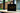 Black tote bag with 'JARA 100% Wild Honey' text on a blurred background