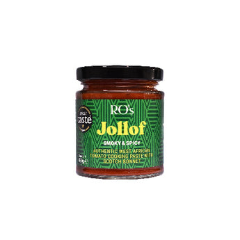 A glass jar of RO's Jollof Smoky & Spicy tomato cooking paste on a plain white background. The jar has a black lid and a green label with yellow text.