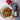 Salad with raspberries and a bottle of Womersley Raspberry Vinegar on a table.