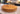 Round solid hardwood chopping board showing natural grain