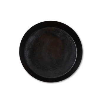 Dark circular tray on a black background