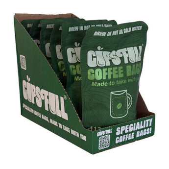 A green CUPFULL Specialty Coffee Bags retail display box with several individual coffee bag packets arranged inside, shown on a plain white background.