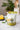 Sapling tea refill package with a cocktail and lemon on a table