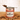 Can of hot chocolate with chocolate flakes on a wooden surface