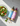 TOSS salad dressing bottles next to a fresh garden salad on marble