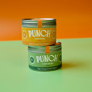 Two tins labeled 'Punch' on a green and orange background