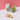 Blendsmiths bamboo whisk with a glass of green tea on a pink background