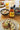 Bottle of Crust Welsh Honey Mustard Sauce on a breakfast table with toast and fruit.