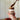 Person spreading chocolate caramel spread from a jar labeled 'Gawst' on a wooden surface.