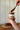 Person spreading chocolate caramel spread from a jar labeled 'Gawst' on a wooden surface.