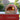 Red DELIVITA pizza oven with a pizza inside on a outdoor kitchen counter.
