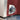 Control knob on a red appliance with visible brand logo