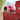 Red outdoor pizza oven with a transparent door on a stand with drawers.