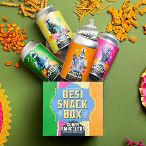 Desi Snack Box with colorful cans and snacks on a green background