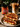 Grilled cheese sandwich with Tandoori Tomato Chutney, glass of iced coffee, and jar of chutney on a table.