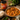 Curry Masala Paste jar with a bowl of curry and rice on a wooden table.
