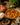 Curry Masala Paste jar with a bowl of curry and rice on a wooden table.