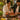 Two people preparing food together with a jar of Tiger Tikka Marinade on a wooden table.