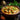 Bowl of creamy chicken curry with garnishes on a wooden table