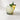 Cocktail with a pineapple wedge and mint leaf on a light surface