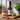 Bottle of Womersley Raspberry Vinegar on a wooden board with raspberries and mint leaves.
