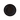 Dark circular tray on a black background