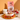 A bag of CRWST Grui and Raspberry Granola Clusters sits on a table beside a bowl of granola with yogurt, blueberries, and raspberries, along with a small jar of dried berries and a white pitcher, all set against a warm orange background.