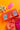 Spice Kitchen Chilli Collection packaging on an orange background with a pink tag and gold bow.