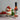 Dessert with strawberries and a bottle of Womersley Strawberry & Mint Vinegar on a table.