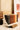 Bookshelf with books and a wooden base on a light-colored surface.