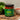 Jar of Ro's Jollof sauce on a wooden cutting board with ingredients in the background