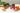 Assorted jars of food products on a white surface with a neutral background