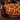 Pizza with a bottle of bbq sauce on a wooden surface